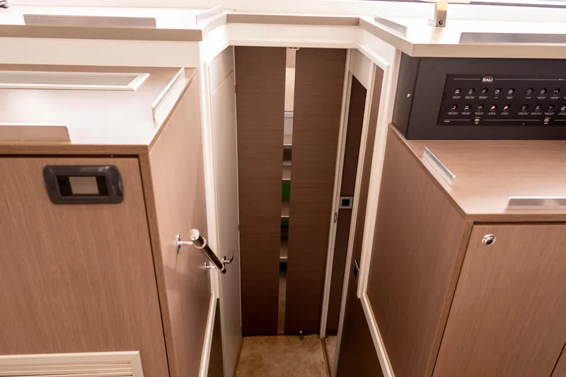 Tatani Yacht Photos Pics Interior view of a 2021 Bali 4.8 yacht, featuring modern wood paneling and control panel.