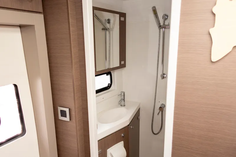 Tatani Yacht Photos Pics Modern bathroom in 2021 Bali 4.8 yacht with shower, sink, and mirror.