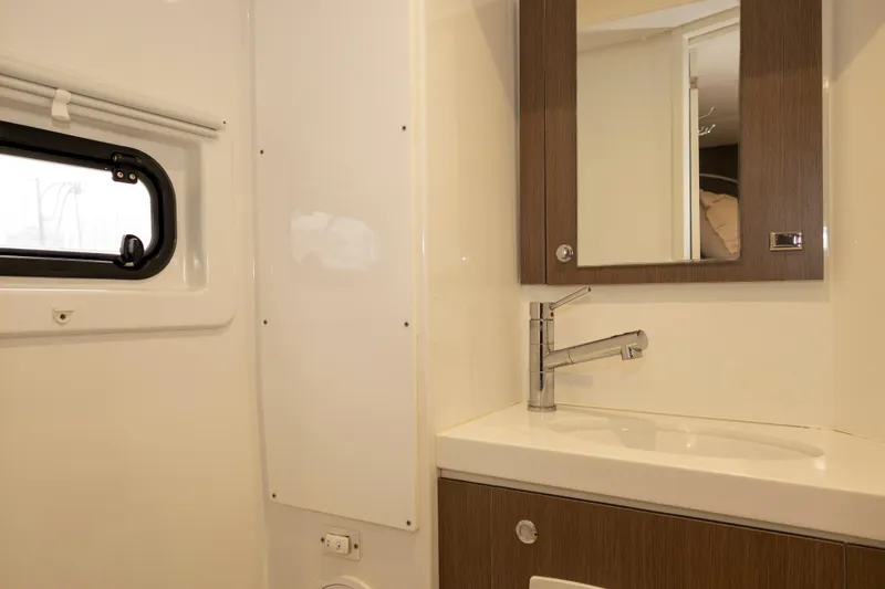 Tatani Yacht Photos Pics Modern bathroom interior in 2021 Bali 4.8 model yacht, featuring sleek sink and mirror.