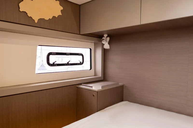 Tatani Yacht Photos Pics Modern interior cabin of 2021 Bali 4.8 yacht with window and storage.