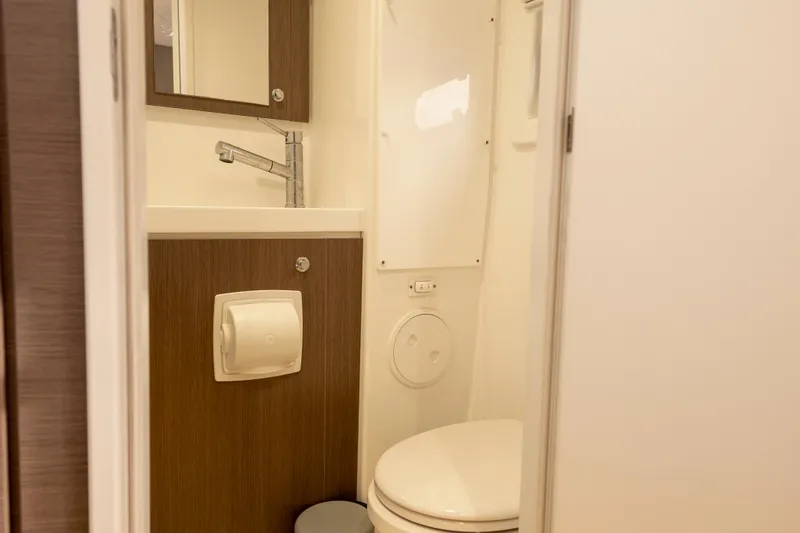 Tatani Yacht Photos Pics Compact bathroom in 2021 Bali 4.8 model, featuring sink, mirror, and toilet.