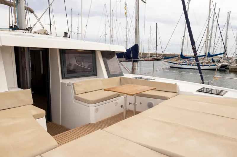 Tatani Yacht Photos Pics 2021 Bali 4.8 yacht with spacious deck seating in a marina setting.