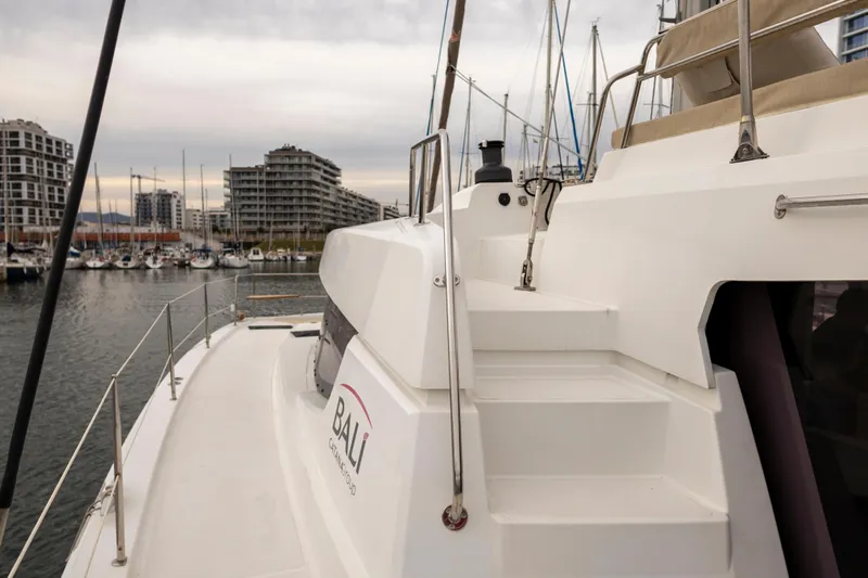 Tatani Yacht Photos Pics Modern Bali 4.8 catamaran docked in marina, showcasing sleek design and spacious deck, 2021 model.