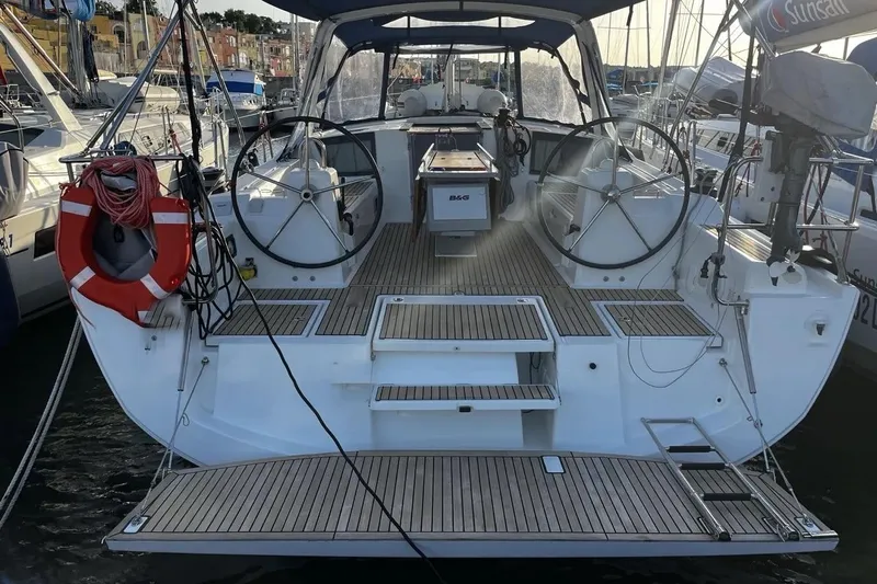  Yacht Photos Pics 2017 Beneteau Oceanis 41.1 yacht with dual steering wheels and teak deck in marina.