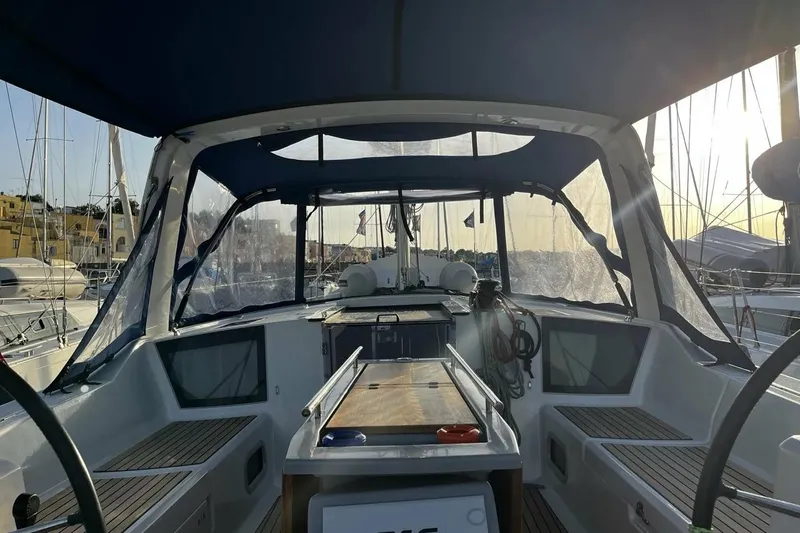  Yacht Photos Pics Cockpit view of 2017 Beneteau Oceanis 41.1 sailboat with protective canopy and marina backdrop.