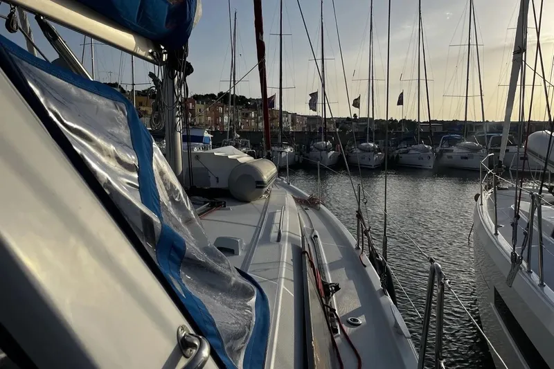  Yacht Photos Pics 2017 Beneteau Oceanis 41.1 sailboat docked in a marina at sunset.