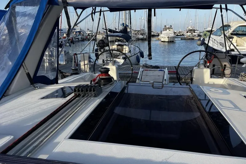  Yacht Photos Pics 2017 Beneteau Oceanis 41.1 sailboat docked in a marina, showcasing cockpit and steering wheels.