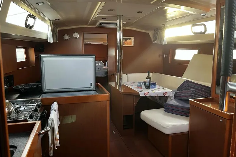  Yacht Photos Pics Interior of 2017 Beneteau Oceanis 41.1 yacht with cozy dining area and kitchen.