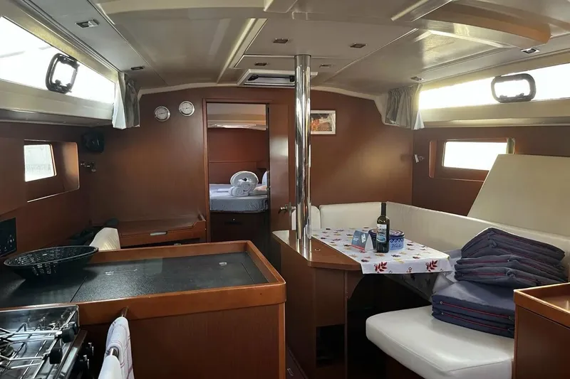  Yacht Photos Pics Interior of 2017 Beneteau Oceanis 41.1 yacht, featuring cozy dining area and modern kitchen.