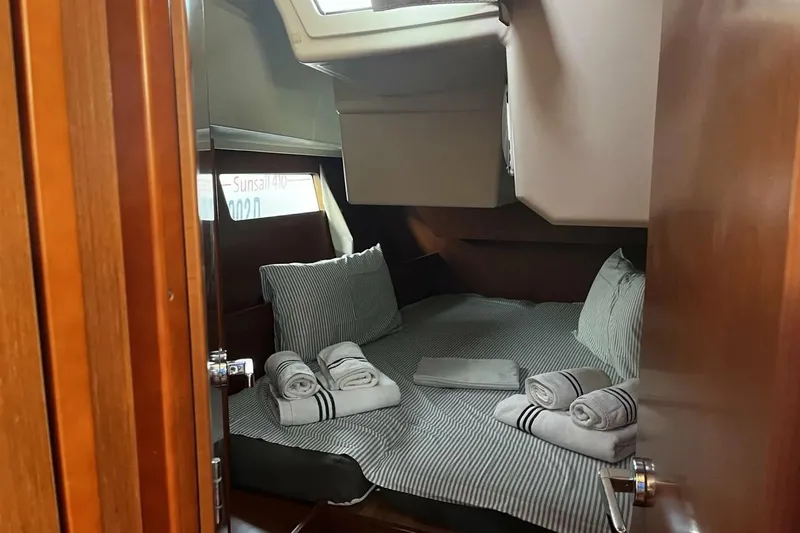  Yacht Photos Pics Cozy cabin interior of 2017 Beneteau Oceanis 41.1 with neatly arranged bedding and towels.