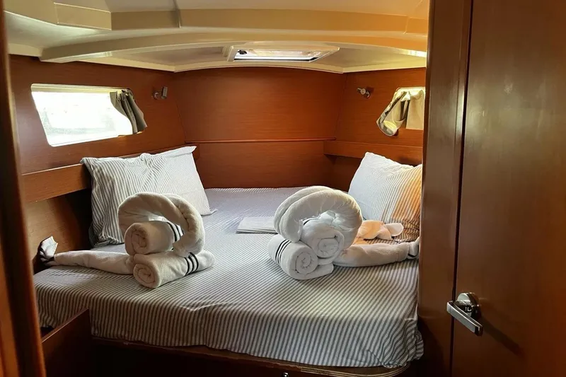  Yacht Photos Pics Luxurious cabin interior of 2017 Beneteau Oceanis 41.1 yacht with neatly arranged towels.