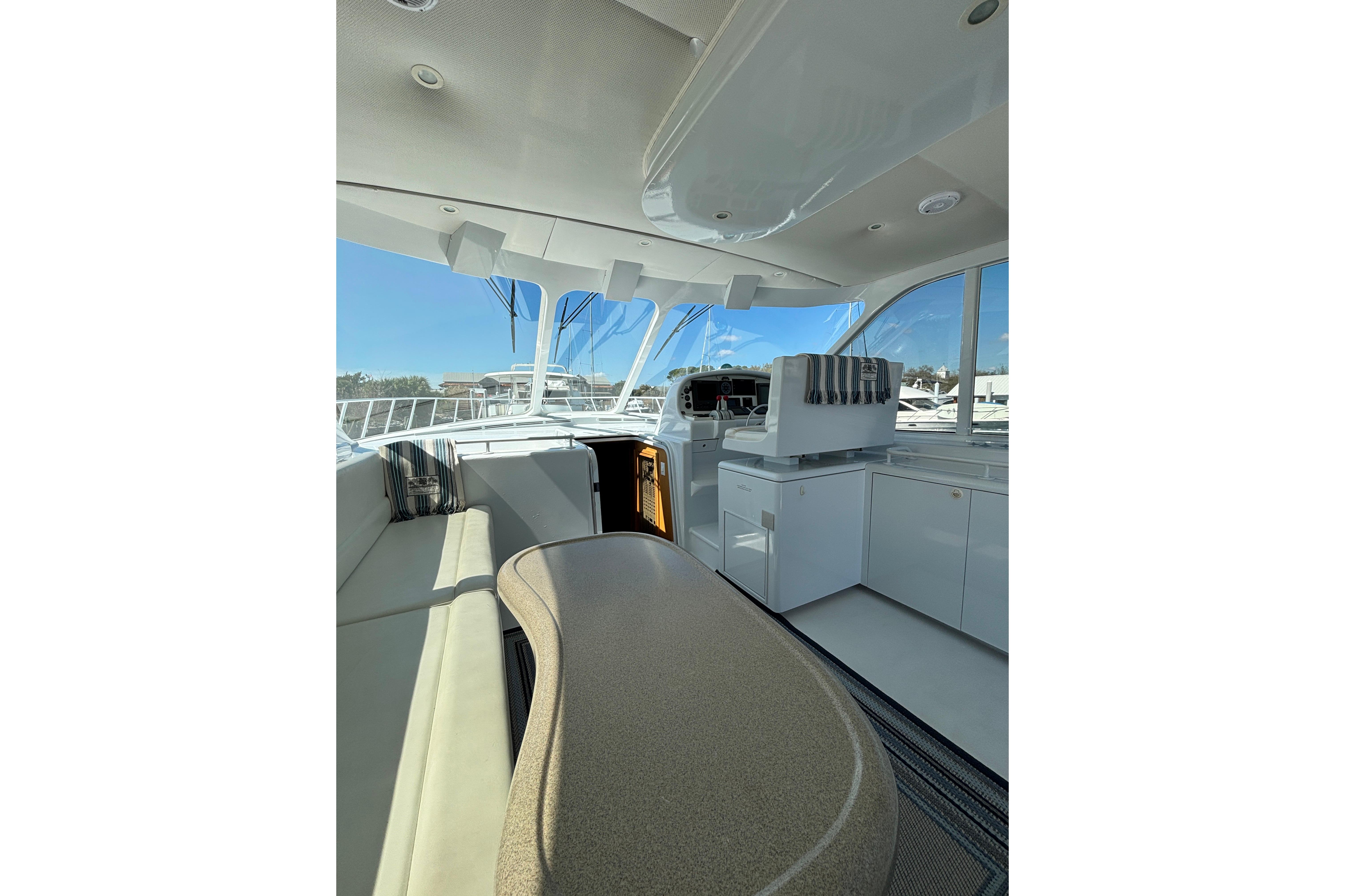 Luxurious interior of a 2006 Dixon 52 yacht with modern seating and helm.