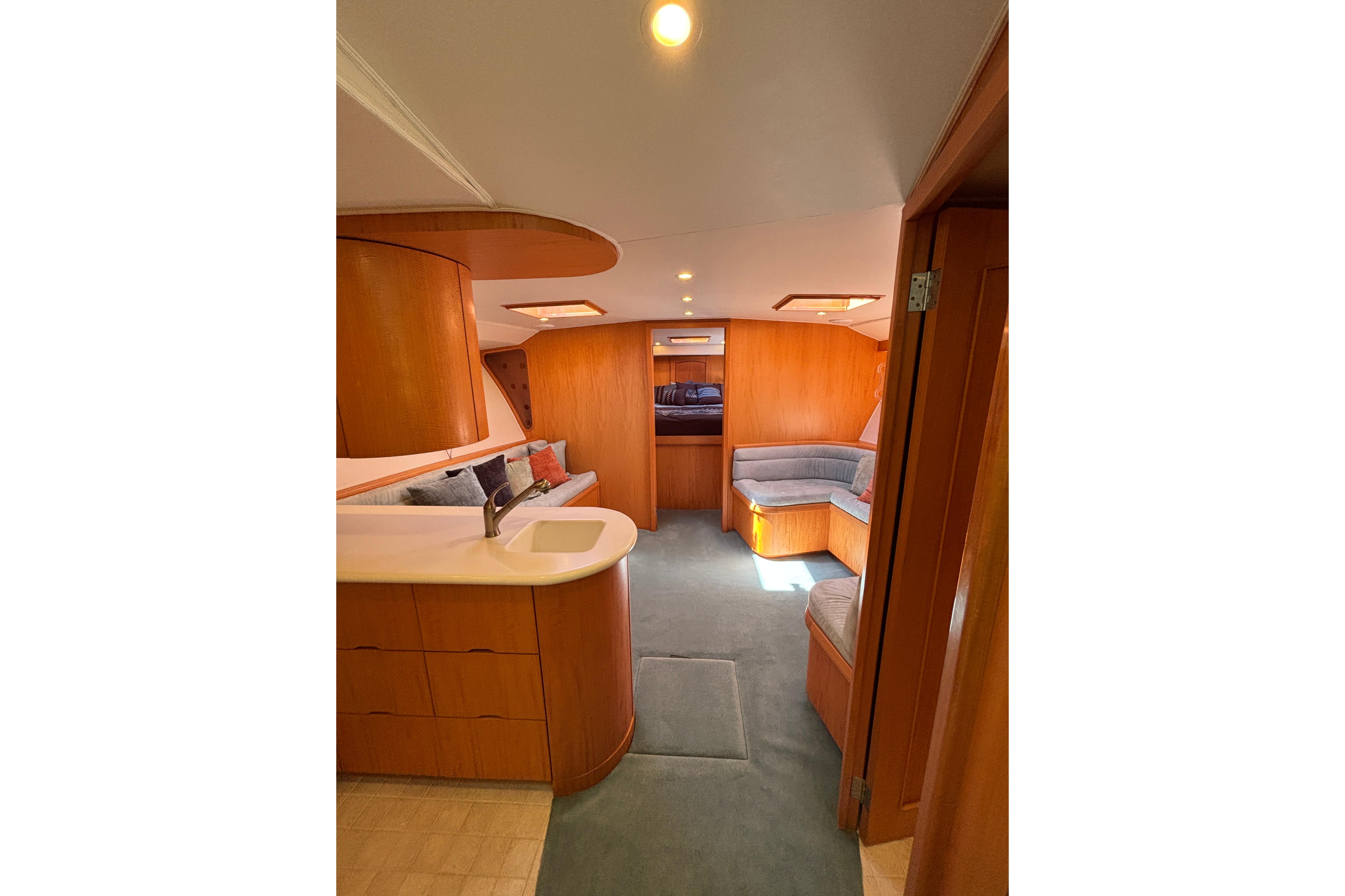 Luxurious 2006 Dixon 52 yacht interior with modern wood finish and cozy seating area.