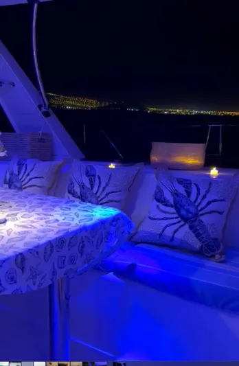 Una Vida Yacht Photos Pics Cozy yacht interior with lobster-themed decor, ambient lighting, and ocean view. Leopard 47, 2004 model.