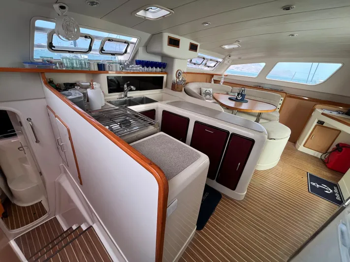 Una Vida Yacht Photos Pics Interior of a 2004 Leopard 47 yacht featuring a modern kitchen and dining area.