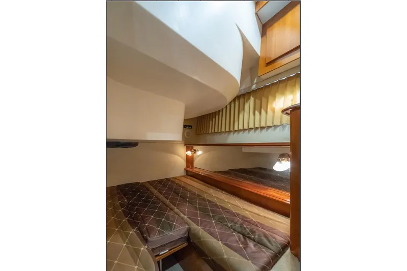  Yacht Photos Pics Interior cabin of 2004 Carver 420 Mariner yacht with cozy bed and warm lighting.