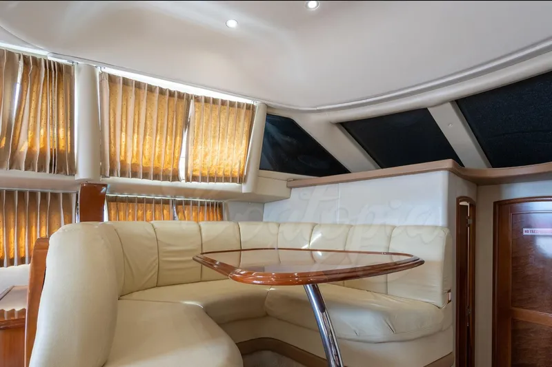  Yacht Photos Pics Luxurious interior of 2004 Carver 420 Mariner yacht with plush seating and elegant table.