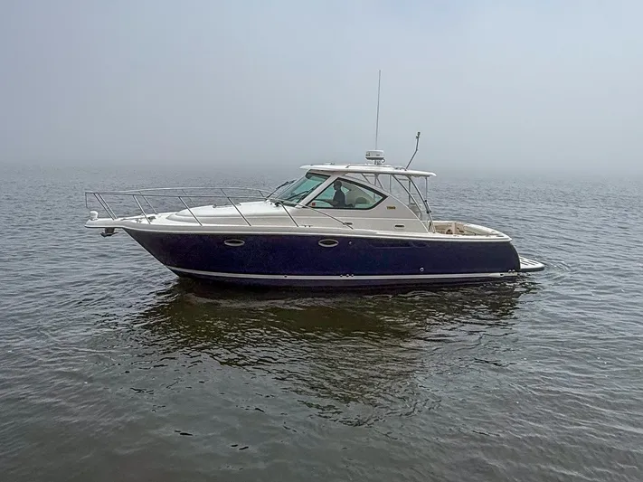 Alipa Yacht Photos Pics 2013 Tiara Yachts 3100 Open boat on calm water, side view.