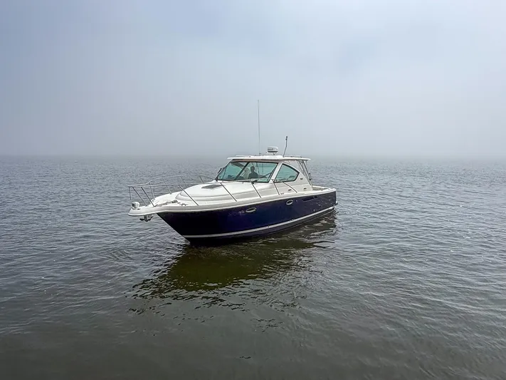 Alipa Yacht Photos Pics 2013 Tiara Yachts 3100 Open boat on calm water under a foggy sky.