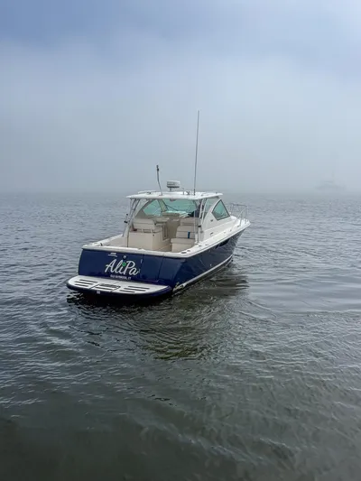 Alipa Yacht Photos Pics 2013 Tiara Yachts 3100 Open boat on misty water, rear view.
