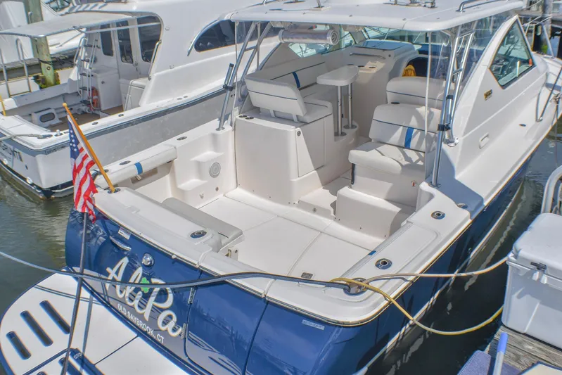 Alipa Yacht Photos Pics 2013 Tiara Yachts 3100 Open docked, featuring spacious seating and American flag.