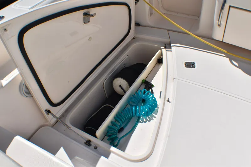 Alipa Yacht Photos Pics Open storage compartment on 2013 Tiara Yachts 3100 Open, featuring coiled blue hose.