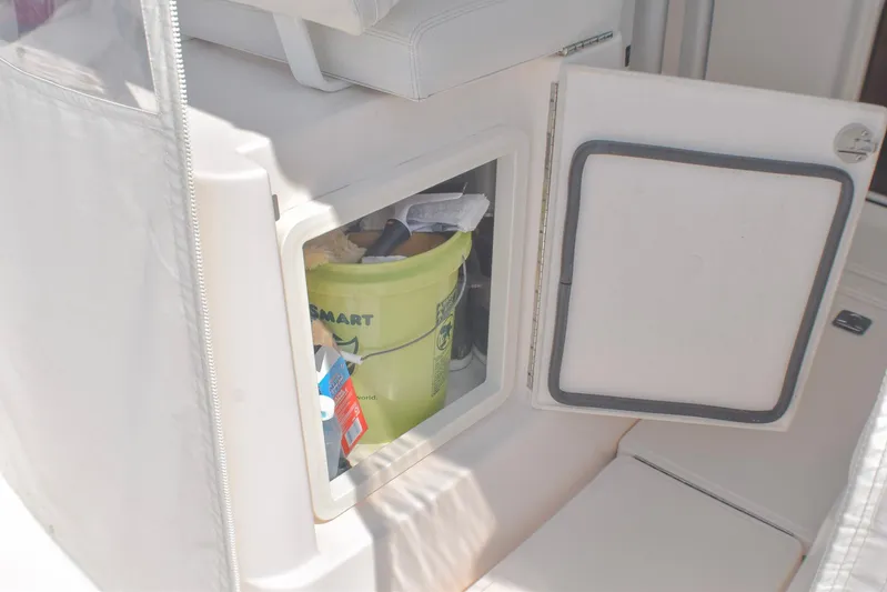 Alipa Yacht Photos Pics Storage compartment on a 2013 Tiara Yachts 3100 Open, containing cleaning supplies.