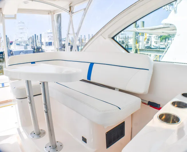 Alipa Yacht Photos Pics 2013 Tiara Yachts 3100 Open interior with white seating and table, docked at marina.