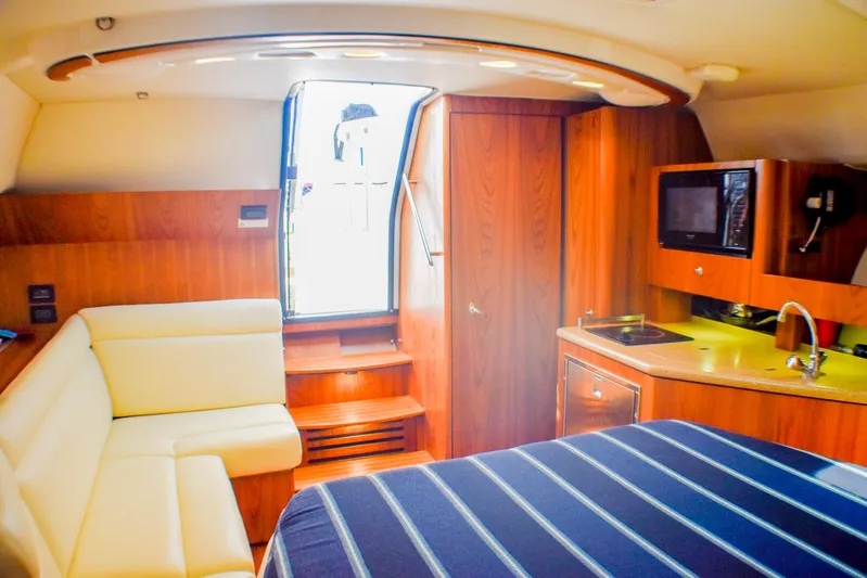 Alipa Yacht Photos Pics Luxurious interior of 2013 Tiara Yachts 3100 Open with kitchenette and seating area.