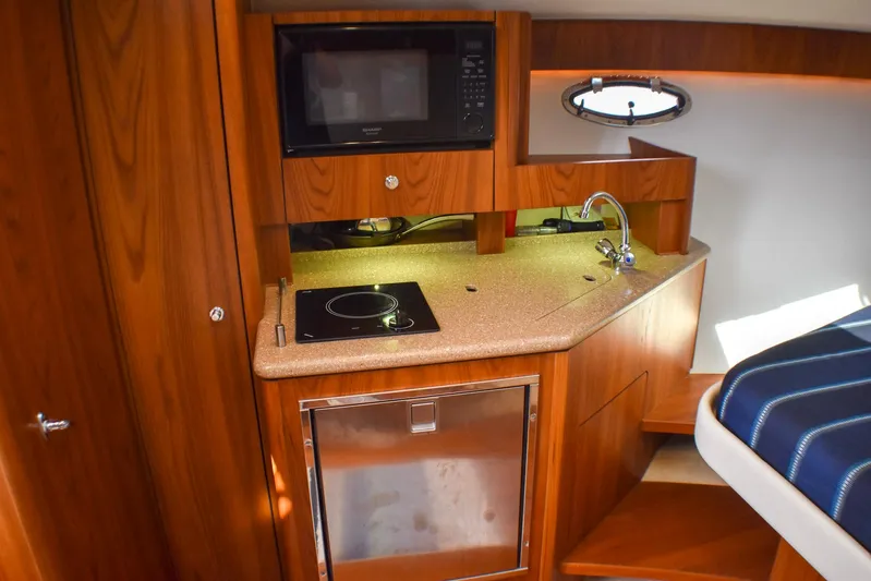Alipa Yacht Photos Pics 2013 Tiara Yachts 3100 Open interior kitchen with microwave, sink, and stove.