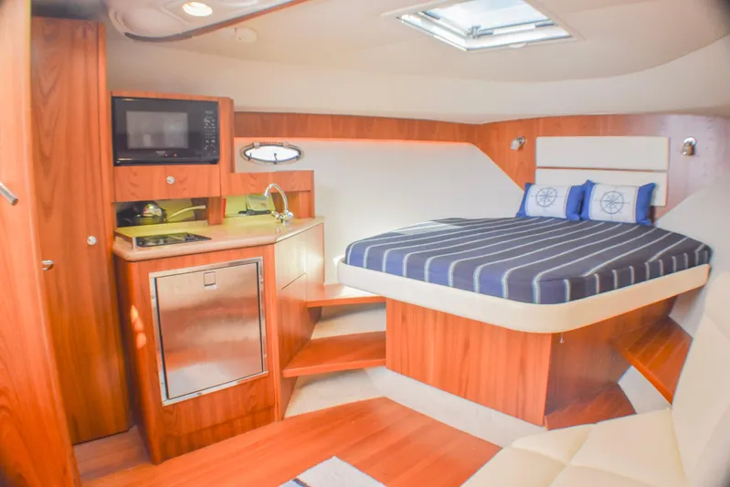 Alipa Yacht Photos Pics 2013 Tiara Yachts 3100 Open interior with bed, kitchenette, and wood finish.