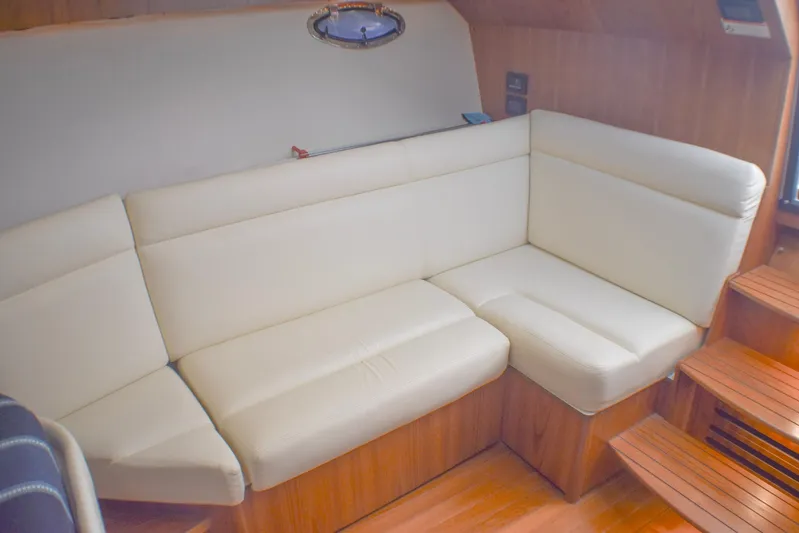 Alipa Yacht Photos Pics Luxurious interior of 2013 Tiara Yachts 3100 Open with cream leather seating.