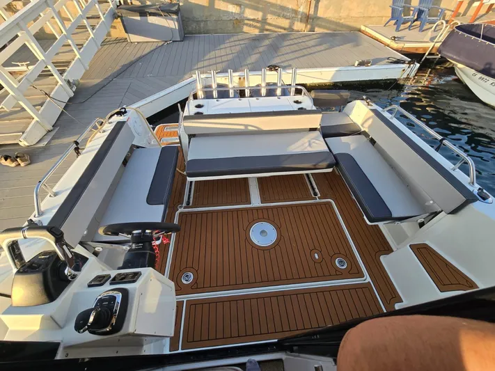 Down Time Yacht Photos Pics 2020 Jeanneau NC 895 Sport boat with spacious deck and seating at the marina.