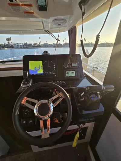 Down Time Yacht Photos Pics 2020 Jeanneau NC 895 Sport helm with navigation display and steering wheel.