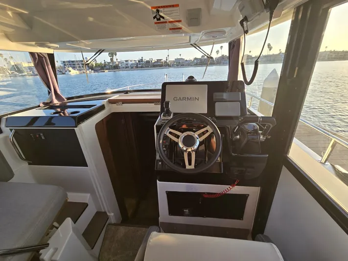 Down Time Yacht Photos Pics Interior view of 2020 Jeanneau NC 895 Sport boat with Garmin navigation system.