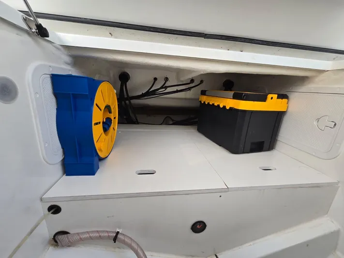 Down Time Yacht Photos Pics Storage compartment in a 2020 Jeanneau NC 895 Sport boat with equipment and wiring.