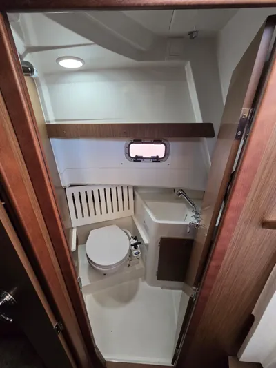 Down Time Yacht Photos Pics 2020 Jeanneau NC 895 Sport boat bathroom with compact design and modern fixtures.
