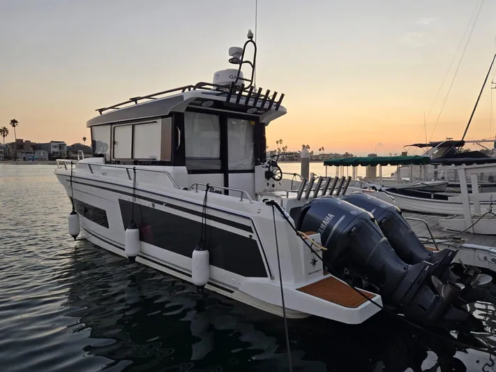 Down Time Yacht Photos Pics 2020 Jeanneau NC 895 Sport boat docked at sunset with dual Yamaha engines.