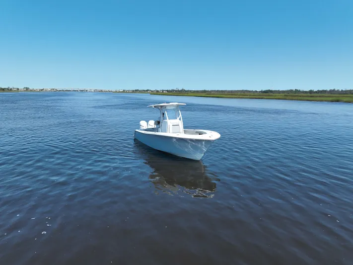 Motivated Yacht Photos Pics 2023 Front Runner 26 Center Console boat on calm water under clear blue sky.