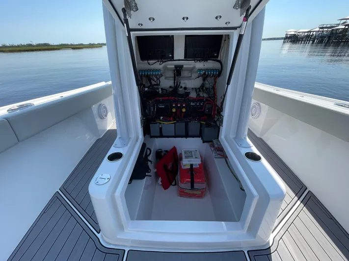 Motivated Yacht Photos Pics 2023 Front Runner 26 Center Console boat interior with open storage compartment.