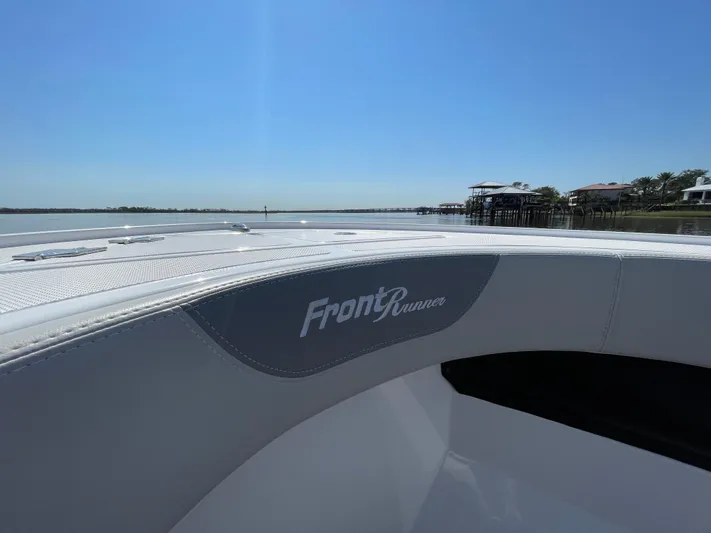 Motivated Yacht Photos Pics 2023 Front Runner 26 Center Console boat on calm water, showcasing sleek design.