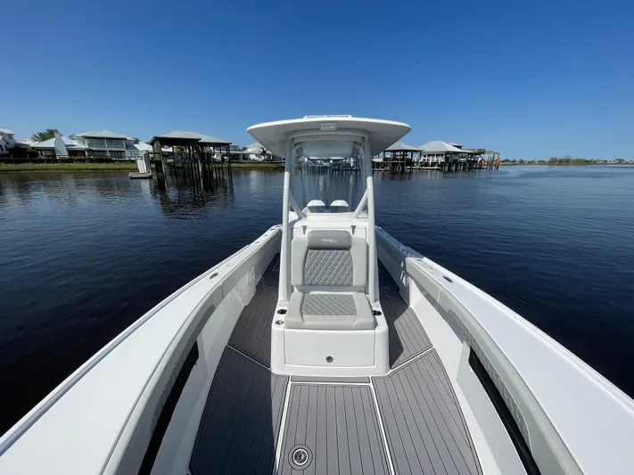 Motivated Yacht Photos Pics 2023 Front Runner 26 Center Console boat on calm water, clear sky background.