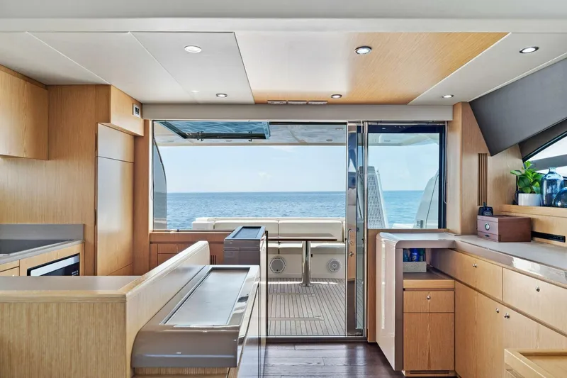 Big Deck Energy Yacht Photos Pics Luxurious interior of 2013 Ferretti Yachts 620 with ocean view through sliding doors.
