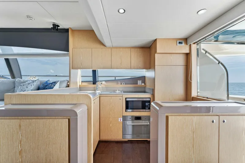 Big Deck Energy Yacht Photos Pics Luxurious kitchen interior of 2013 Ferretti Yachts 620 with modern appliances and ocean view.
