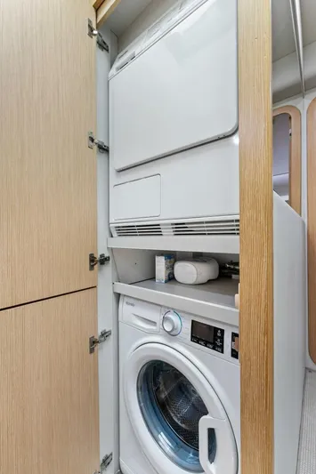 Big Deck Energy Yacht Photos Pics Laundry area inside 2013 Ferretti Yachts 620, featuring stacked washer and dryer.
