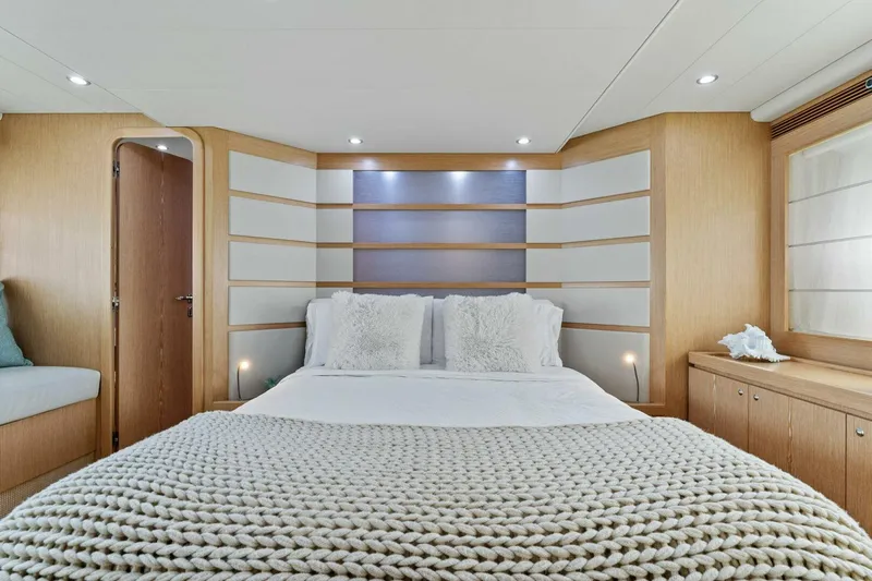 Big Deck Energy Yacht Photos Pics Luxurious bedroom interior of 2013 Ferretti Yachts 620 with modern design and cozy bedding.