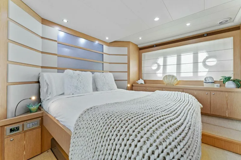 Big Deck Energy Yacht Photos Pics Luxurious bedroom interior on a 2013 Ferretti Yachts 620, featuring elegant decor and cozy bedding.