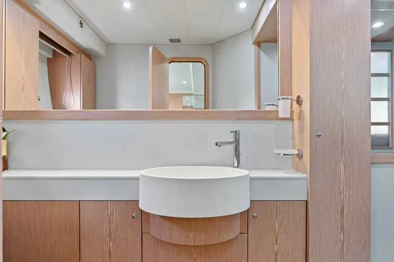 Big Deck Energy Yacht Photos Pics Luxurious bathroom interior of 2013 Ferretti Yachts 620 with modern sink and wood accents.