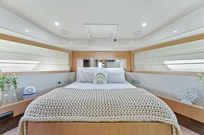 Big Deck Energy Yacht Photos Pics Luxurious bedroom interior of 2013 Ferretti Yachts 620 with elegant decor and cozy bedding.