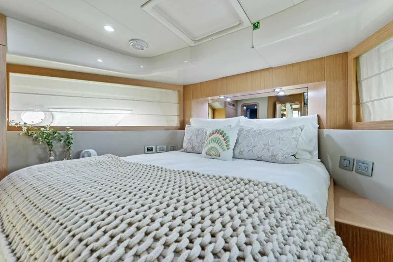 Big Deck Energy Yacht Photos Pics Luxurious bedroom interior of 2013 Ferretti Yachts 620 with cozy bedding and modern design.